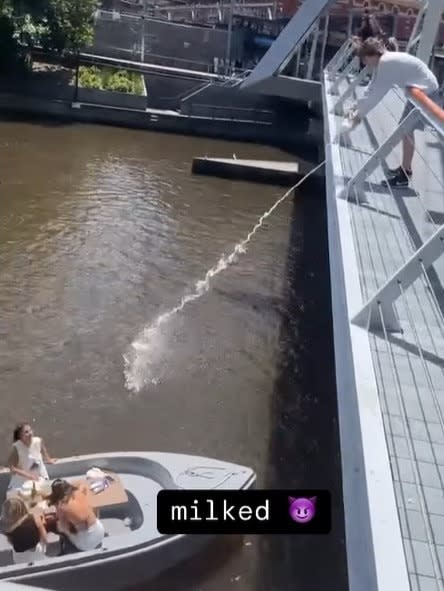 The boy is seen dumping milk on the passengers while they are on a GoBoat ride on the Yarra River. Instagram / giddynokiddy