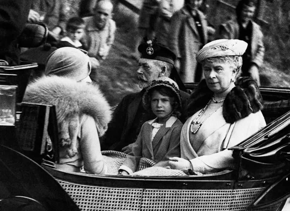 Princess Elizabeth sits between her grandparents, King George V and Queen Mary of England, facing her mother Elizabeth, the Duchess of York, as the Royal Family returns from a service at Crathie Church.<span class="copyright">Hulton-Deutsch Collection/Corbis/Getty Images</span>