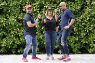 Tirso Luis, left, Ana Paez, and German Pinelli, right, members of the band Los 3 de la Habana, pose for a photograph, Thursday, Oct. 22, 2020, in Miami. The Cuban artists who sought asylum in the U.S. have composed a salsa song in support of President Donald Trump, which is now being used as a full-fledged campaign ad. (AP Photo/Lynne Sladky)