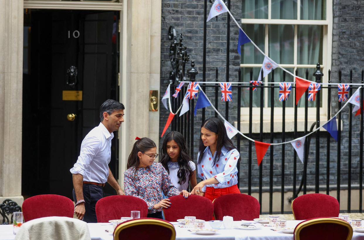 British Prime Minister Rishi Sunak, his wife Akshata Murty and daughters Anoushka and Krishna attend the Big Lunch event on Downing Street to celebrate the coronation of Britain's King Charles (Reuters)
