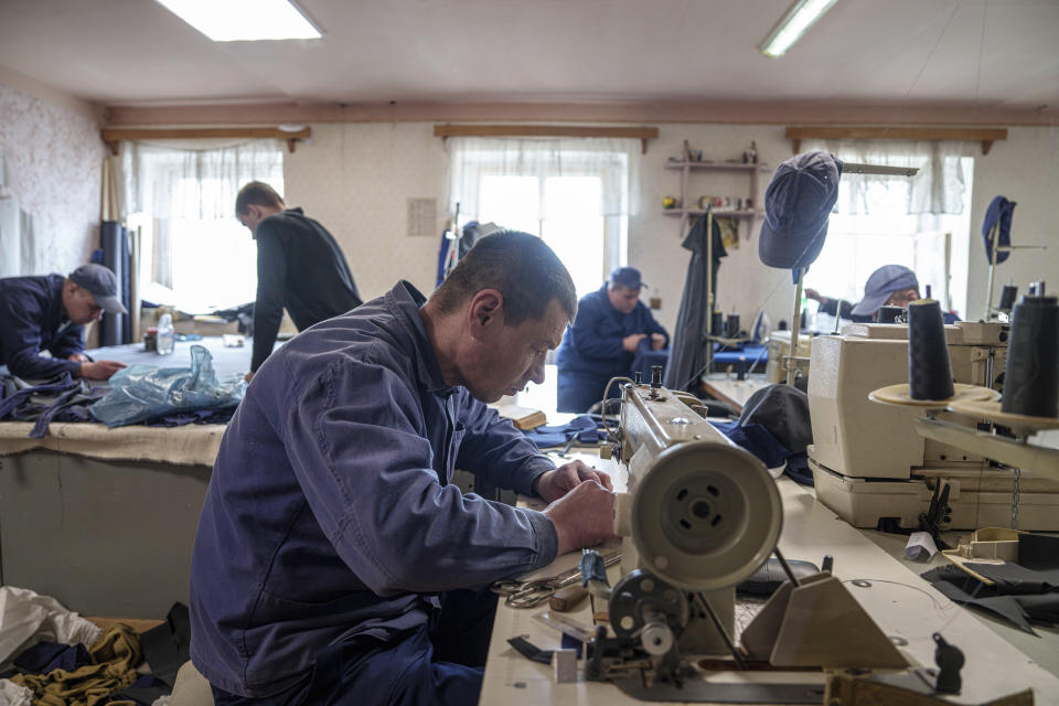 A Russian prisoner of war sews at a detention center in Ukraine's Lviv region, Thursday, April 25, 2024. AP visited the center as part of a small group of journalists on the condition that its exact location be withheld and spoke with Russian POWs, who gave only their first names. (AP Photo/Evgeniy Maloletka)