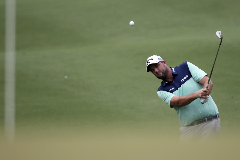 Marc Leishman of Australia follows his shot on the seventh hole during round two of the CIMB Classic golf tournament at Tournament Players Club (TPC) in Kuala Lumpur, Malaysia, Friday, Oct. 12, 2018. (AP Photo/Vincent Phoon)