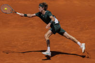 Andrey Rublev of Russia returns the ball during a match against Daniel Evans of Britain at the Mutua Madrid Open tennis tournament in Madrid, Thursday, May 5, 2022. (AP Photo/Bernat Armangue)