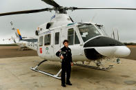 <p>Carla Rozalen, 29, a helicopter pilot, poses for a picture in front of a Bell 412 twin-engine utility helicopter at the FAASA Group in Palma del Rio, Cordoba, on February 27, 2018. (Photo: Cristina Quicler/AFP/Getty Images) </p>