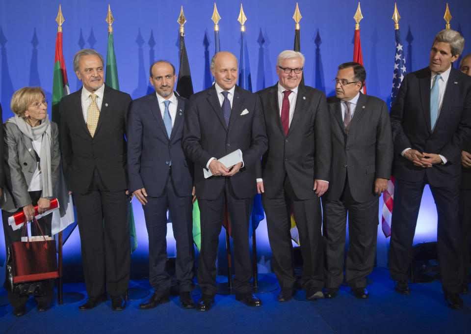 From left, Italian Foreign Minister Emma Bonino, Saudi Foreign Minister Prince Saud al-Faisal, Syrian National Coalition Chief Ahmad al-Jarba, French Foreign Minister Laurent Fabius, German Foreign Minister Frank-Walter Steinmeier, Egyptian Foreign Minister Nabil Fahmy, US Secretary of State John Kerry, pose for a group photo prior to a joint press conference at the foreign ministry in Paris, Sunday, Jan. 12, 2014. The head of Syria’s main Western-backed opposition group says its international supporters agree that Bashar Assad has no future as the country’s leader. The statement Sunday from Ahmad al-Jarba comes as U.S. Secretary of State John Kerry and top envoys from 10 other countries raised the pressure for peace talks that would bring his Syrian National Coalition face-to-face with the government the rebels are trying to overthrow. (AP Photo/Michel Euler)