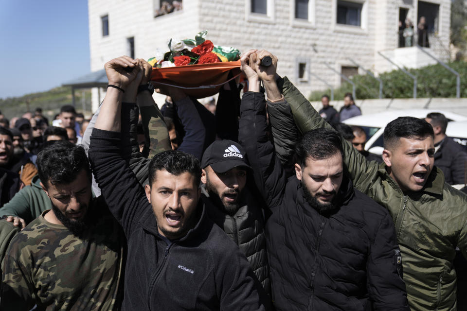 Mourners carry the body of Amr al-Najjar, 11, draped in the Hamas flag, during his funeral in the West Bank village of Burin, near Nablus, Tuesday, March 5, 2024. Palestinian media reports that he was shot during an Israeli military incursion into the village of Burin. The Israeli military says they opened fire in the village and are aware of reports of a minor being killed. According to the Palestinian Red Crescent emergency service, the child suffered a gunshot to the head before dying of his wounds. (AP Photo/Majdi Mohammed)