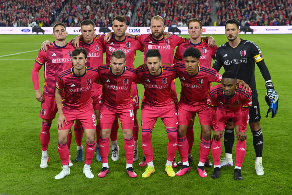 Members of St. Louis City SC pose for a photo prior to an MLS soccer match against Charlotte FC, Saturday, March 4, 2023, in St. Louis. (AP Photo/Joe Puetz)