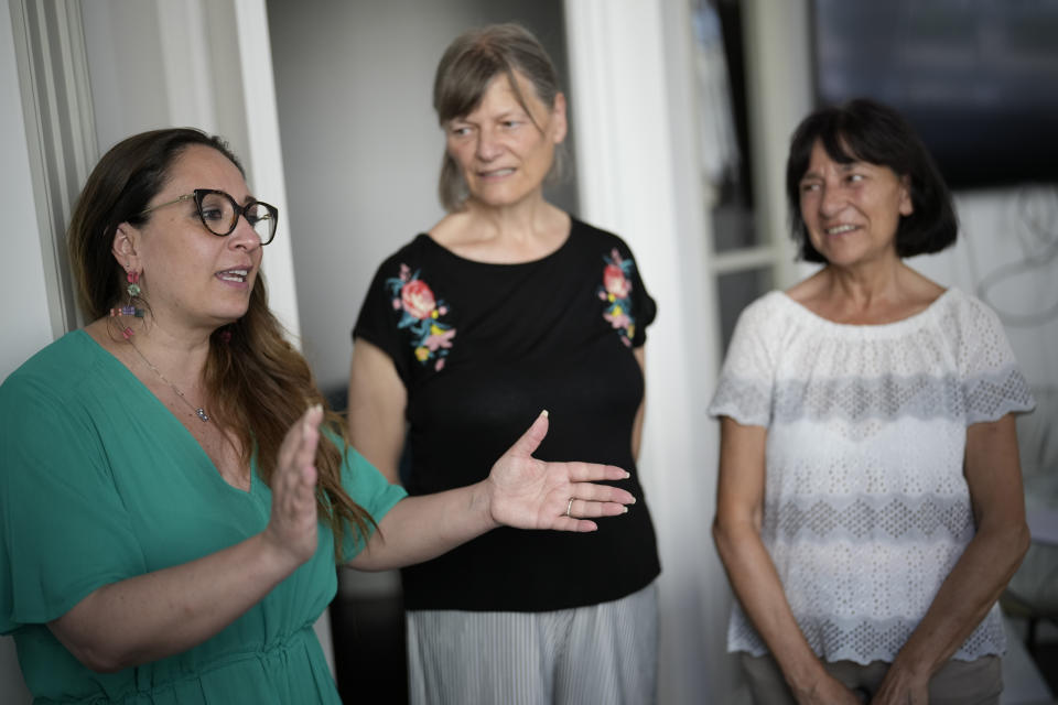 Lawyer Laura Sgro', left, talks to Mirjam Kovac, center, and Gloria Branciani, as they arrive for an interview with the Associated Press, in Rome, Friday, June 28, 2024. Kovac and Branciani are two of five women who urged Catholic bishops around the world to remove from their churches mosaics by ex-Jesuit artist Rev. Marko Rupnik after they accused him of psychologically, spiritually and sexually abusing them. (AP Photo/Andrew Medichini)