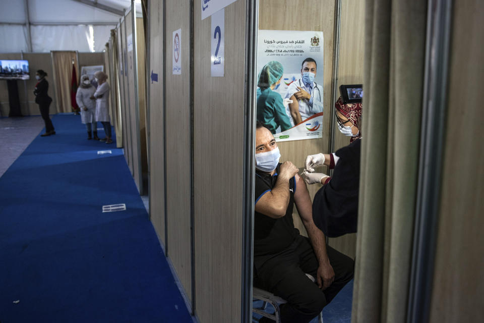 FILE - In this Jan. 29, 2021, file photo a Moroccan nurse administers the AstraZeneca COVID-19 vaccine to a health worker, on the first day of the vaccination campaign, in Rabat, Morocco. The suspension of the AstraZeneca vaccine in several European countries could fuel skepticism about the shot far beyond their shores, potentially threatening the rollout of a vaccine that is key to the global strategy to stamp out the coronavirus pandemic, especially in developing nations. (AP Photo/Mosa'ab Elshamy, File)