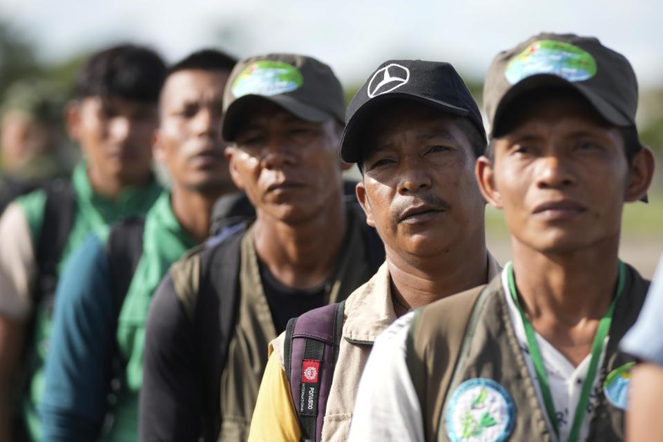 FILE - Indigenous men line up upon arrival to the airport in San Jose del Guaviare, Colombia, May 21, 2023, to help search of four Indigenous children who are missing after a deadly plane crash. The children braved the jungle for 40 days before being found alive. (AP Photo/Fernando Vergara, File)