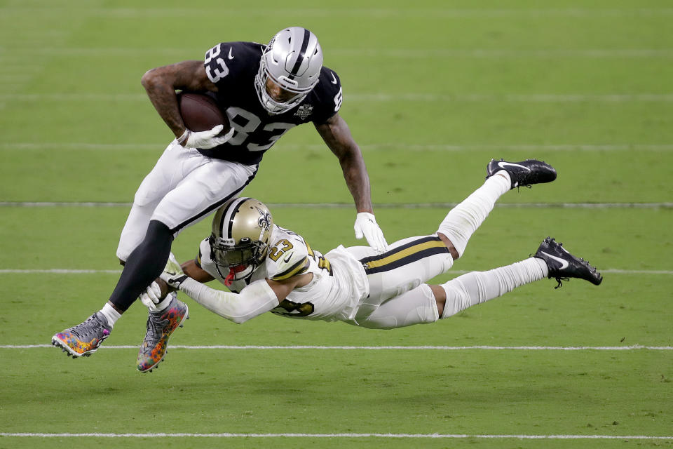 New Orleans Saints cornerback Marshon Lattimore (23) tackles Las Vegas Raiders tight end Darren Waller (83) during the first half of an NFL football game, Monday, Sept. 21, 2020, in Las Vegas. (AP Photo/Isaac Brekken)