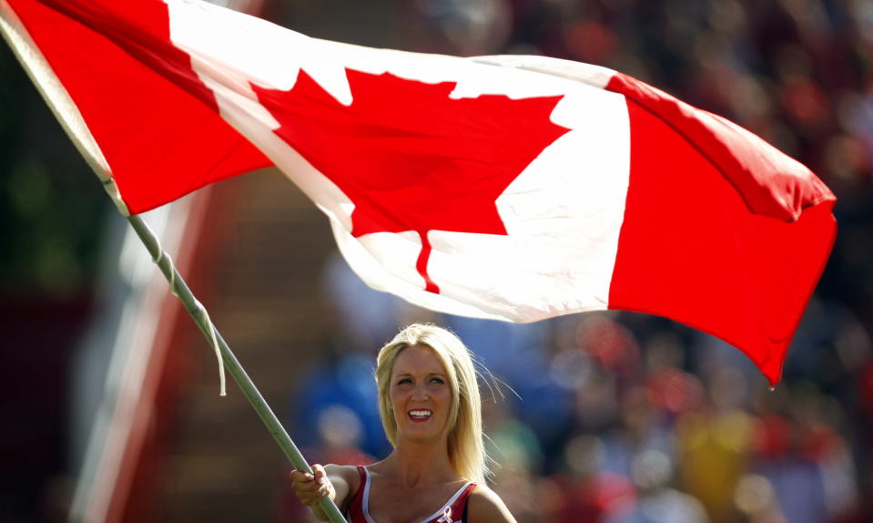 A Calgary Stampeders' Outrider flies the Canadian flag on Canada Day before the start of CFL football action against the Montreal Alouettes in Calgary, Alta., Sunday, July 1, 2012. THE CANADIAN PRESS/Jeff McIntosh