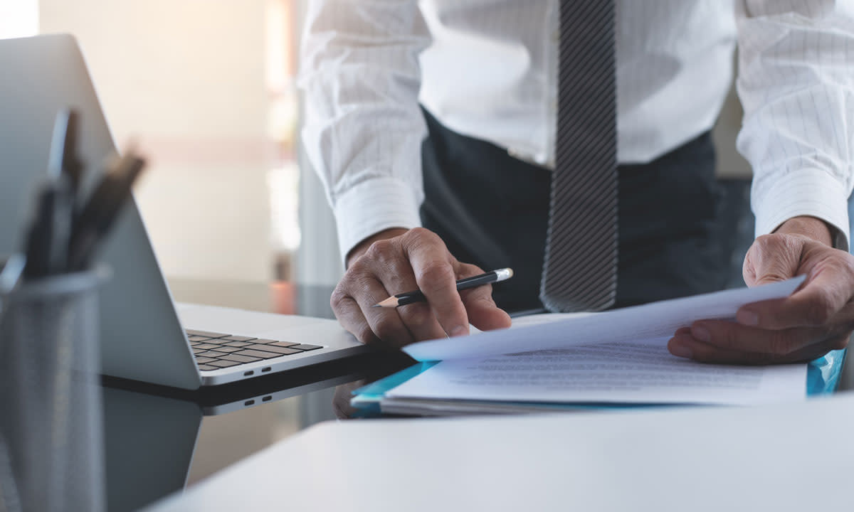 This is a photo of a person filling out paperwork.