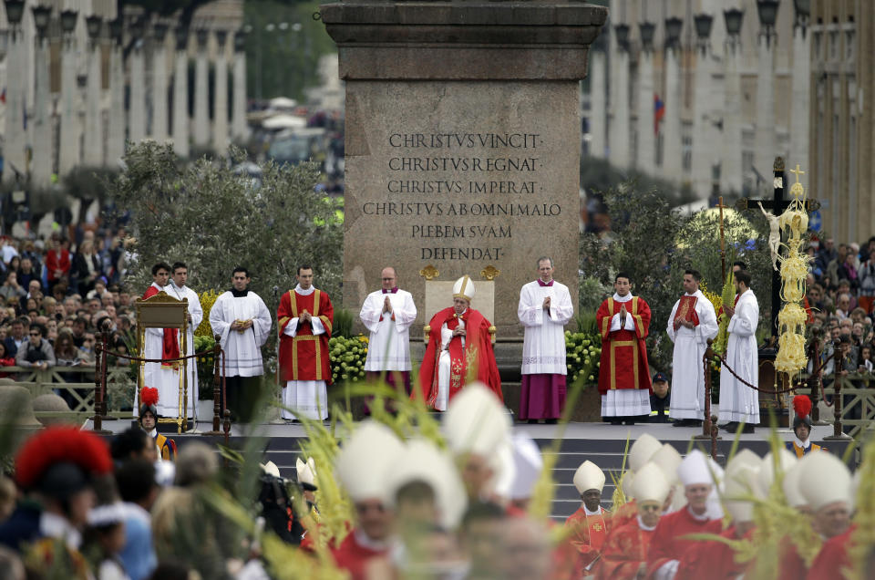 Pope Francis, background center, celebrates a Palm Sunday mass in St. Peter's Square, at the Vatican, Sunday, April 13, 2014. (AP Photo/Gregorio Borgia)