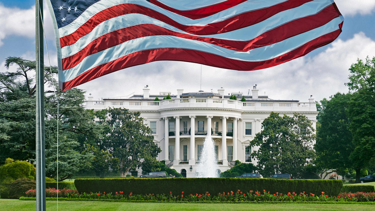 the White House, with american flag in foreground