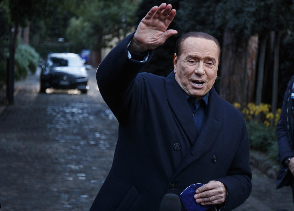 FILE - Former Italian Premier Silvio Berlusconi waves to media following a meeting with center-right leaders in Rome, on Dec. 23, 2021. Former premier Silvio Berlusconi has bowed out of Italy’s presidential election set for next week. Berlusconi, 85, said in a statement on Saturday that he had decided to “take another step on the path of national responsibility.” The media mogul insisted he had nailed down enough voters to become head of state, but he asked his supporters not to cast ballots for him. (Roberto Monaldo/LaPresse via AP, File)