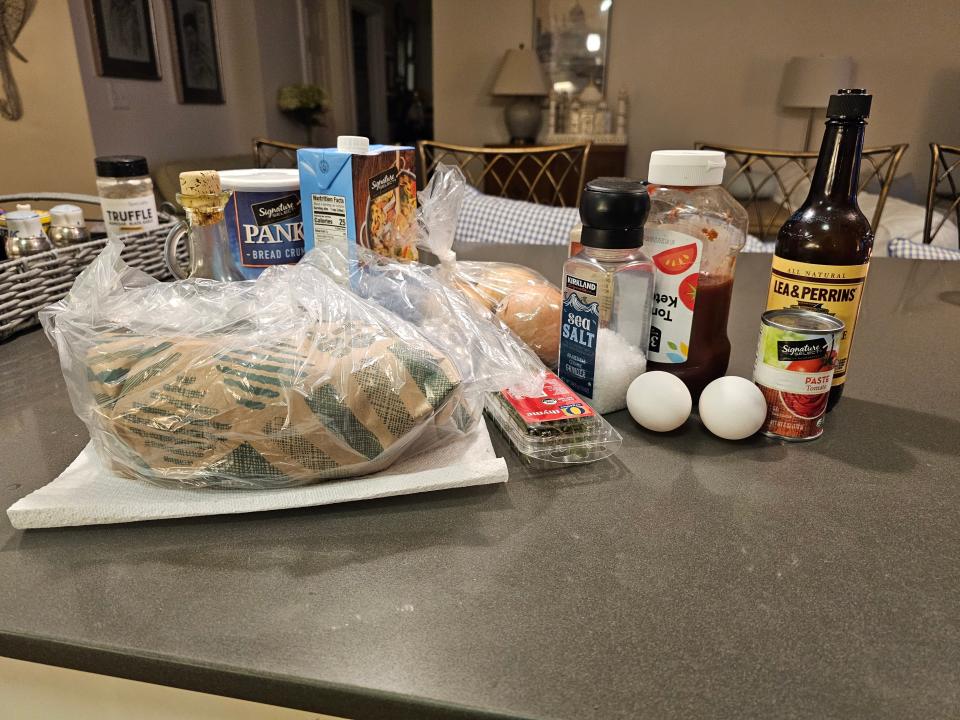 Package of ground meat, salt, panko crumbs, broth, ketchup, and other ingredients on counter