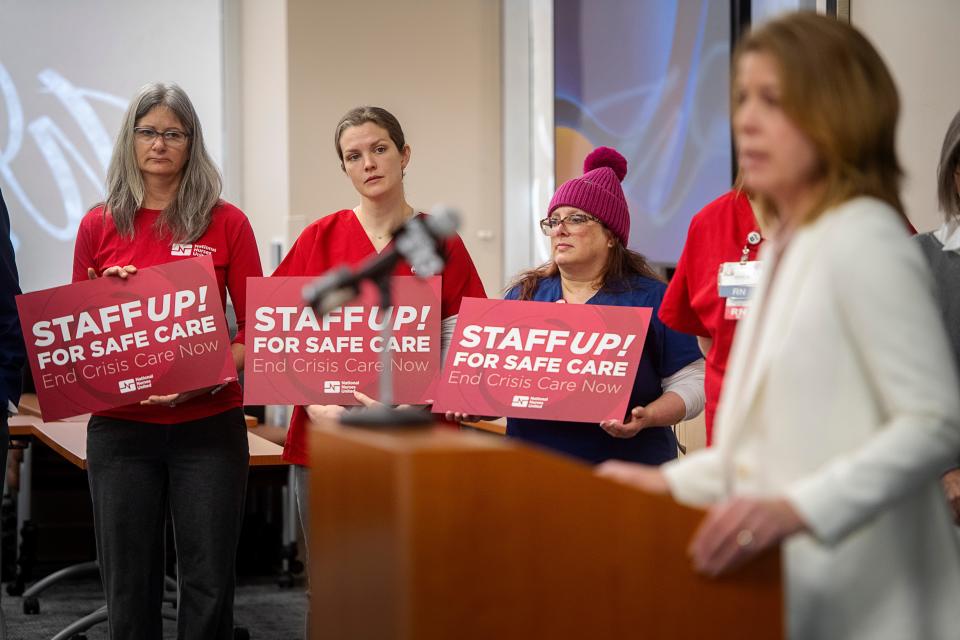 Mission Hospital registered nurses, from left, Jeanne Mould, Molly Zener and Aimee Bovara, listen as Asheville Mayor Esther Manheimer speaks at a press conference February 6, 2024.