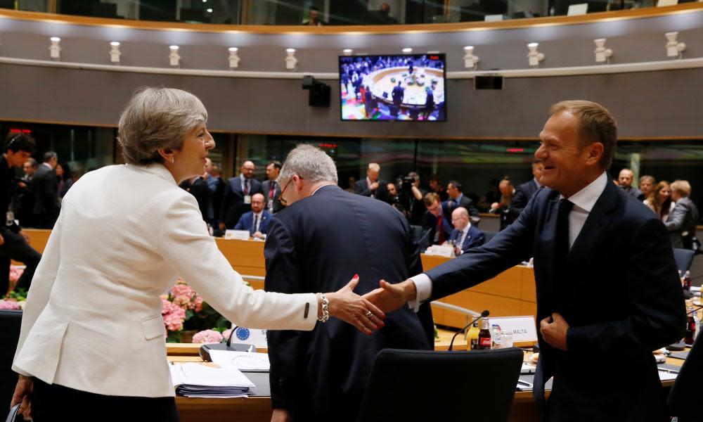 Theresa May shakes hands with Donald Tusk at the EU summit in Brussels.