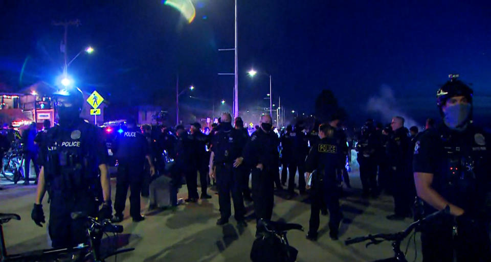 IMAGE: Police clear people from Alki Beach in Seattle on Saturday (KING)