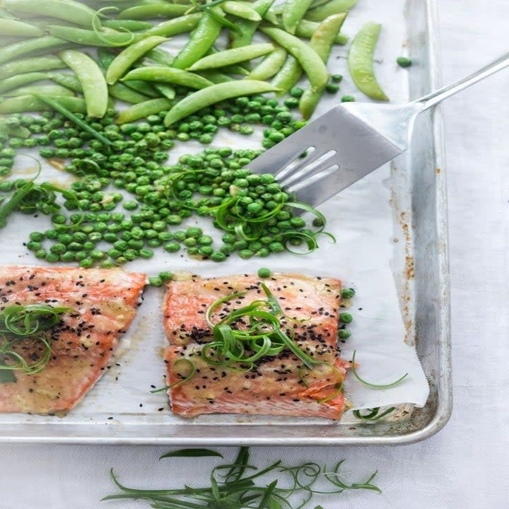 Sheet pan salmon with peas, edamame, and scallions.