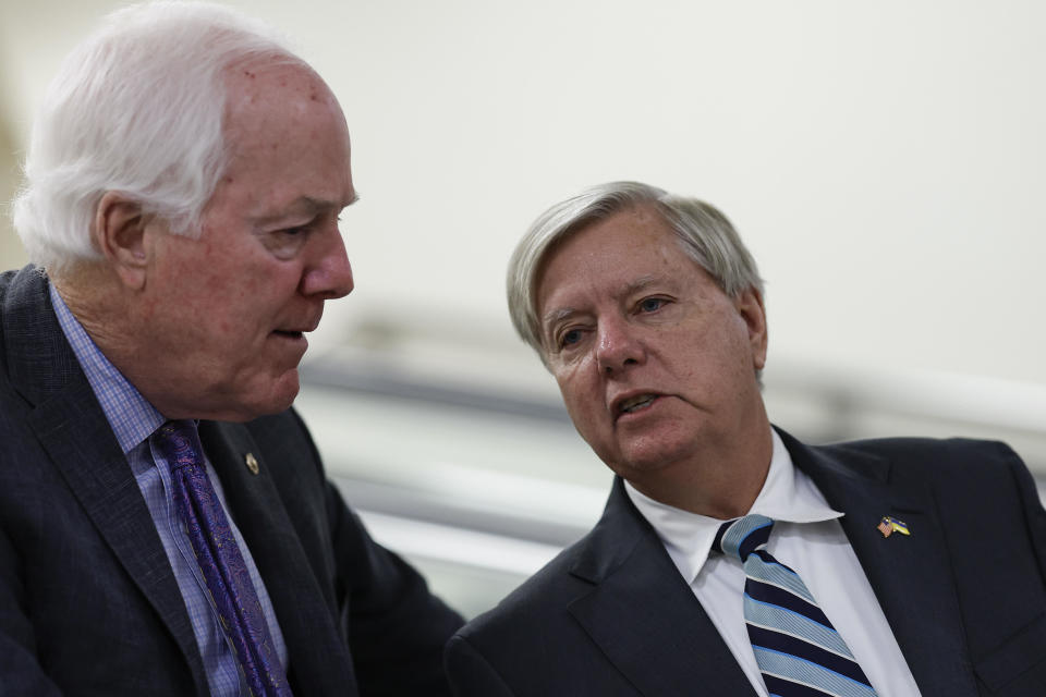 Sen. John Cornyn (R-TX) speaks with Sen. Lindsey Graham (R-SC) as they walk through the Senate Subway to participate in a vote on the Senate floor at the U.S. Capitol Building on Nov. 16, 2022 in Washington, D.C.  / Credit: Anna Moneymaker / Getty Images