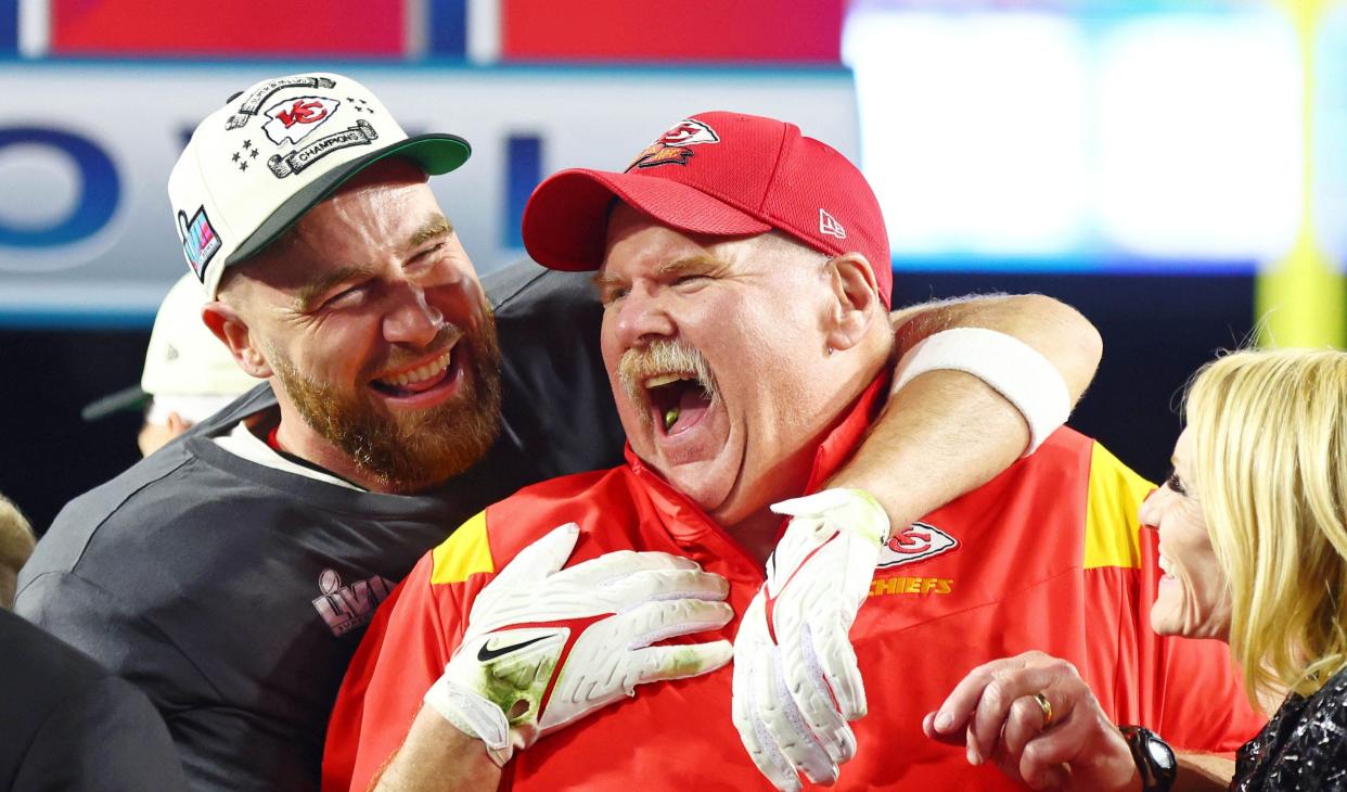 Kansas City Chiefs head coach Andy Reid laughs with tight end Travis Kelce.