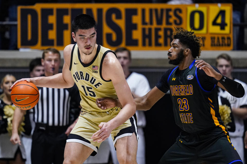 Purdue center Zach Edey (15) is defended by Morehead State forward Dieonte Miles (23) during the first half of an NCAA college basketball game in West Lafayette, Ind., Friday, Nov. 10, 2023. (AP Photo/Michael Conroy)