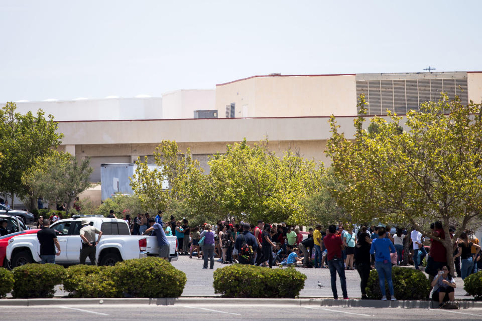 Individuals that were evacuated sit in a parking lot across from a Wal-Mart where a shooting occurred at Cielo Vista Mall in El Paso, Texas, Saturday, Aug. 3, 2019. (Photo: Joel Angel Juarez/AFP/Getty Images)