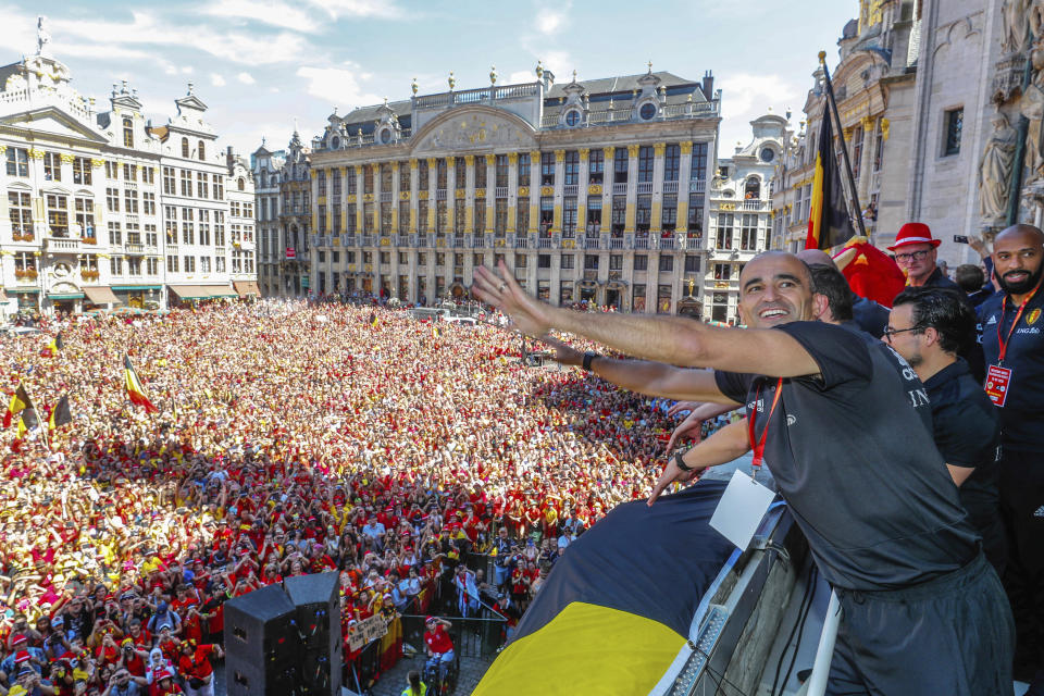 FILE - In this Sunday, July 15, 2018, photo, Belgian soccer team coach Roberto Martinez reacts on the balcony of the city hall at the Grand Place in Brussels. Martinez has signed a new contract to lead the Red Devils through the 2022 World Cup in Qatar. (Yves Herman, Pool Photo via AP, File)