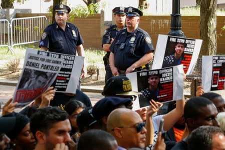 NYPD officers stand guard as people attend a press conference of Gwen Carr, mother of Eric Garner outside Police Headquarters in New York