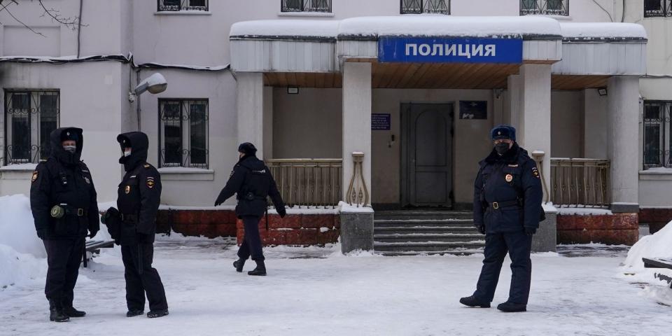 Russian police officers are seen outside a police station on January 18, 2021 in Khimki, outside Moscow, where opposition leader Alexei Navalny is held following his detention at a Moscow airport upon the arrival from Berlin. (Photo by Andrey BORODULIN / AFP) (Photo by ANDREY BORODULIN/AFP via Getty Images)