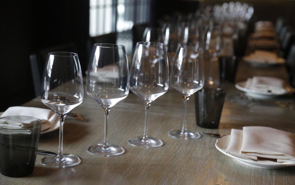 This Feb. 12, 2014, shows a table setting in an upstairs dining room in chef Paul Kahan's restaurant Nico Osteria in Chicago. Kahan is executive chef and one of the owners of One Off Hospitality, working together with his partners _ including Donnie Madia, nominated for best restaurateur in this year’s Beard Awards _ to run seven restaurants in Chicago. He counts among his fans Anthony Bourdain and first lady Michelle Obama, and last year shared the Beard Award for best chef with New York’s David Chang, the man behind the Momofuko restaurants.(AP Photo/M. Spencer Green)