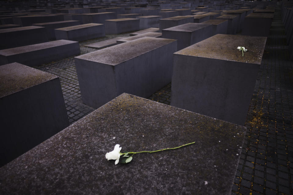 Flowers are laid on concrete slabs of the Memorial to the Murdered Jews of Europe, known as Holocaust Memorial on the 85th anniversary of the November 1938 pogroms in Germany and Austria, in central Berlin, Germany, Thursday, Nov. 9, 2023. According to Israel's Yad Vashem Holocaust memorial, the Nazis killed at least 91 people, vandalized 7,500 Jewish businesses and burned more than 1,400 synagogues during Nov. 9, 1938 pogroms known as Kristallnacht, or "Night of broken Glass." (AP Photo/Markus Schreiber)