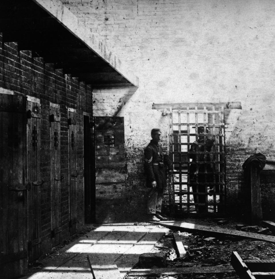 Two soldiers stand beside cells where enslaved Black people were confined in Alexandria, Virginia, circa 1861.  (Photo: Archive Photos via Getty Images)