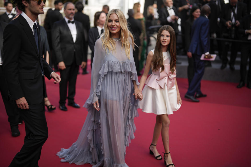 Sienna Miller, left, and Marlowe Sturridge pose for photographers upon arrival at the premiere of the film 'Horizon: An American Saga' at the 77th international film festival, Cannes, southern France, Sunday, May 19, 2024. (Photo by Andreea Alexandru/Invision/AP)