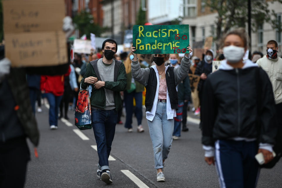 LONDON, UNITED KINGDOM - JUNE 06: Protesters hold placards as they march through central London on June 6, 2020 in London, United Kingdom. The death of an African-American man, George Floyd, while in the custody of Minneapolis police has sparked protests across the United States, as well as demonstrations of solidarity in many countries around the world. (Photo by Hollie Adams/Getty Images)