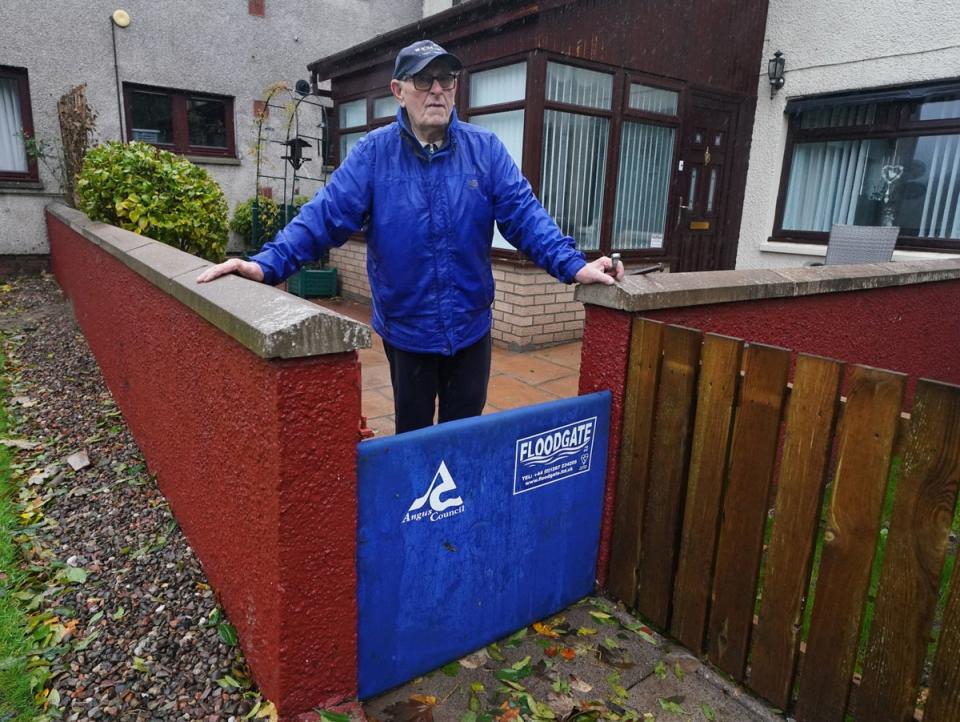 John Stewart with his flood defence outside his home (PA)