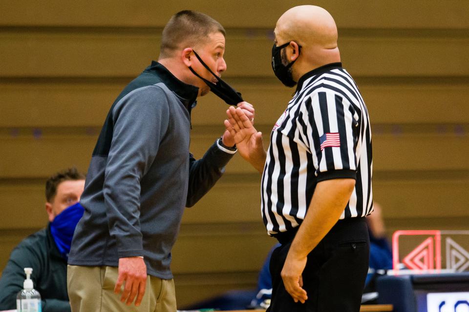 Edwardsburg coach Steve Wright adjusts his mask while talking to a referee before receiving a technical foul during the Buchanan vs. Edwardsburg boys district basketball game Thursday, March 25, 2021 at Niles High School.