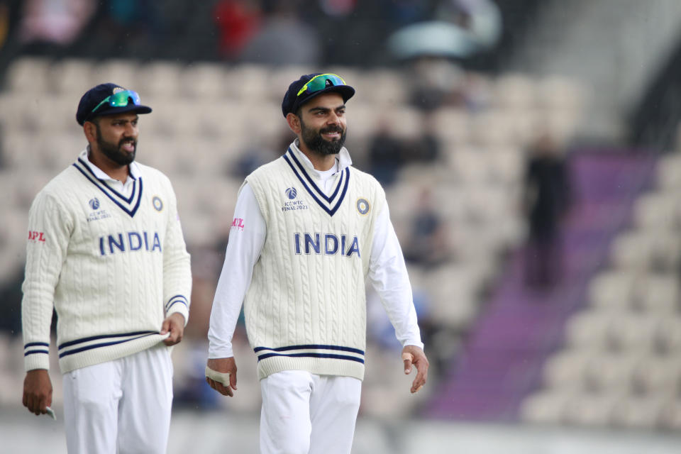 India's captain Virat Kohli, right, stands with teammate Rohit Sharma during the third day of the World Test Championship final cricket match between New Zealand and India, at the Rose Bowl in Southampton, England, Sunday, June 20, 2021. (AP Photo/Ian Walton)