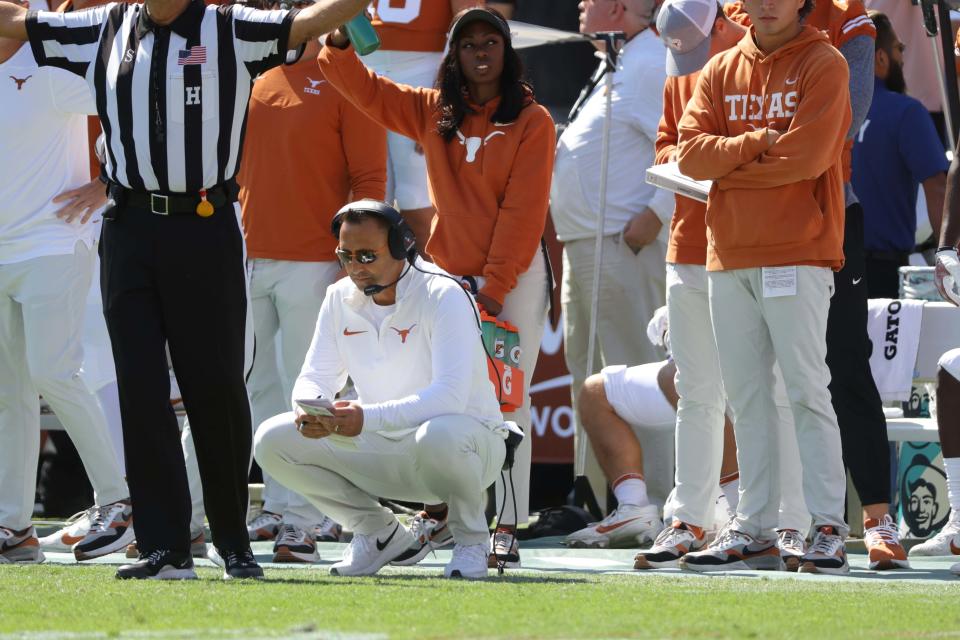Texas coach Steve Sarkisian kneels on the sideline during the Longhorns' 34-30 loss to Oklahoma last Saturday at the Cotton Bowl.