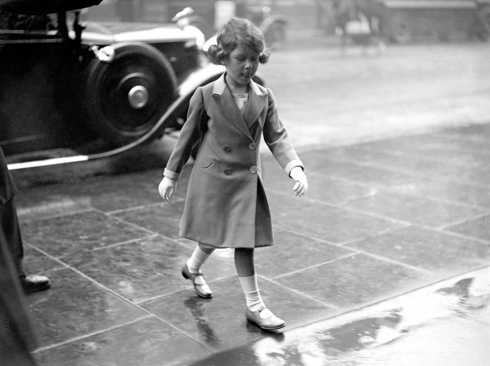 <p>A young princess walks through the rain in London (PA Archive) </p>