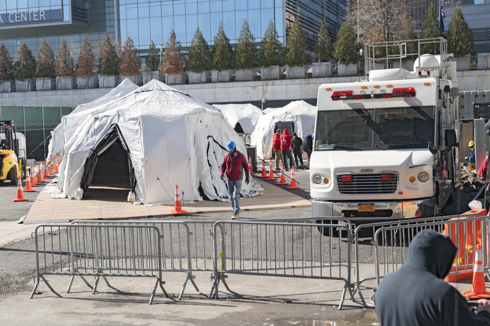 Workers build a makeshift morgue outside of Bellevue Hospital in New York City. The COVID-19 outbreak has quickly overwhelmed local hospitals with patients. (Photo: Ron Adar / Echoes Wire/Barcroft Media via Getty Images)