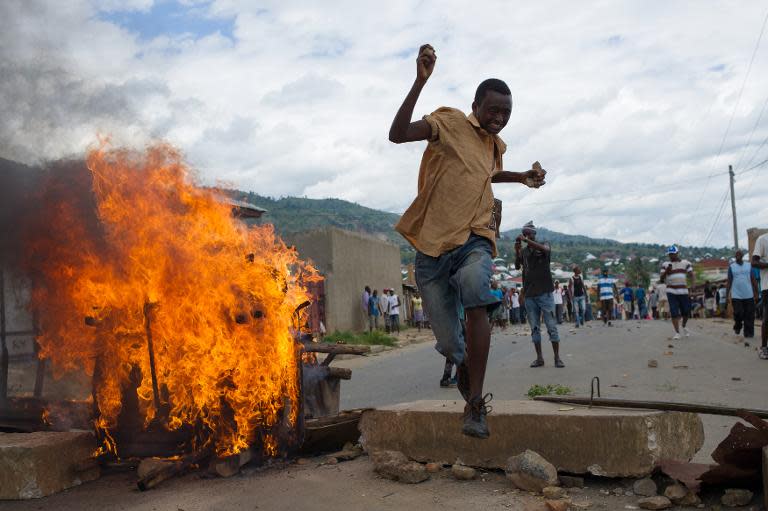 A Burundian protester jumps over a barricade in the Mugasa neighbourhood of Bujumbura on May 6, 2015