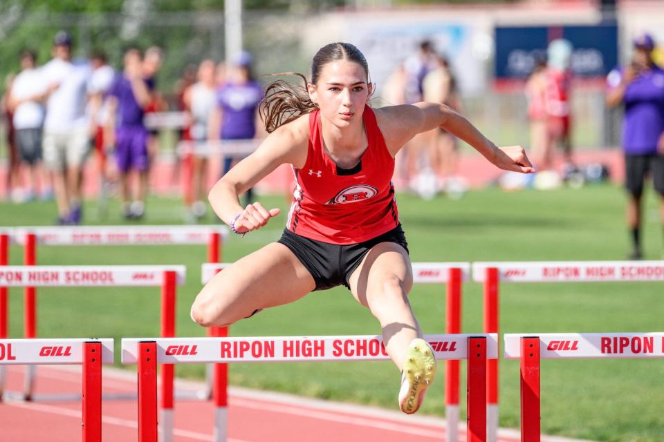 Ripon's Starla Skiles jumps over a hurdle during one of the Indians' track meet during the 2023-24 season.