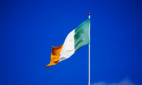 Irish flag against blue sky<br>GettyImages-528230432