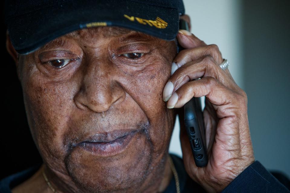 Fred Norris talks on the phone Tuesday, Feb. 1, 2022, with an old wartime buddy, Phil Styles. Styles currently lives in Chicago but the two talk on the phone often. Norris gets emotional as they speak about injustices they say they faced. 