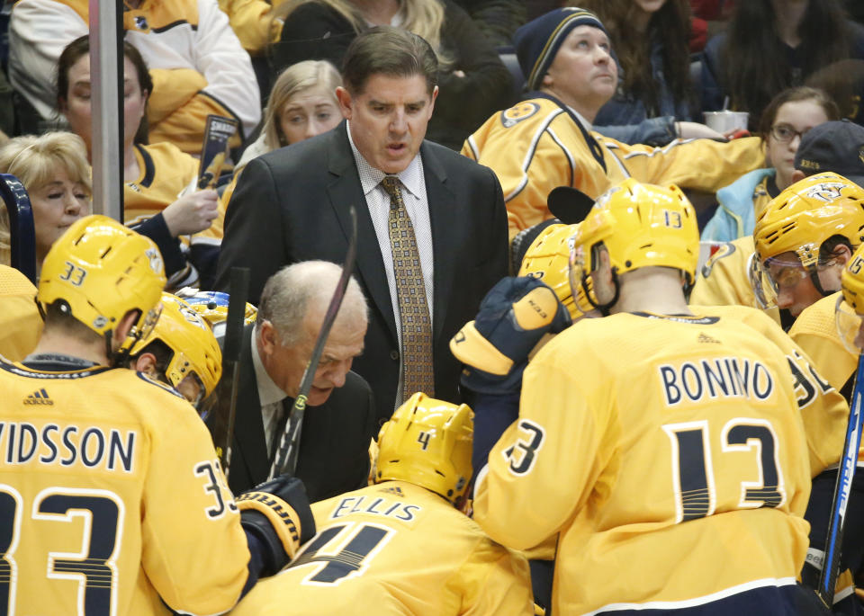 FILE - In this Dec. 29, 2018, file photo, Nashville Predators coach Peter Laviolette, center, and associated coach Kevin McCarthy, center left, talk to players during a timeout in an NHL hockey game against the New York Rangers in Nashville, Tenn. The team announced Monday, Jan. 6, 2020, that both Laviolette and McCarthy had been fired. (AP Photo/Mark Humphrey, File)