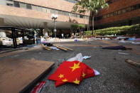 A Chinese flag lies amid debris at Hong Kong Polytechnic University in Hong Kong, Friday, Nov. 29, 2019. Hong Kong police were preparing Friday to reopen access to the university campus after blocking it for 12 days to try to arrest protesters holed up inside. (AP Photo/Vincent Thian)