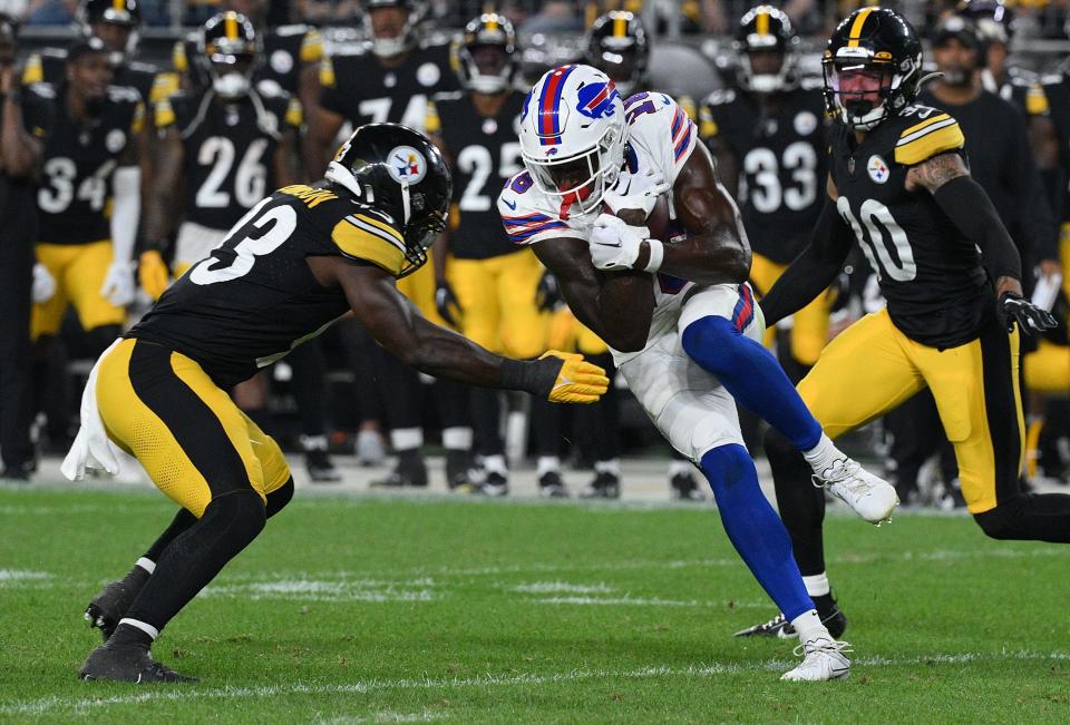 Justin Shorter of the Buffalo Bills makes a catch as Mark Robinson of the Pittsburgh Steelers attempts a tackle in the fourth quarter during a preseason game at Acrisure Stadium on August 19, 2023 in Pittsburgh, Pennsylvania.